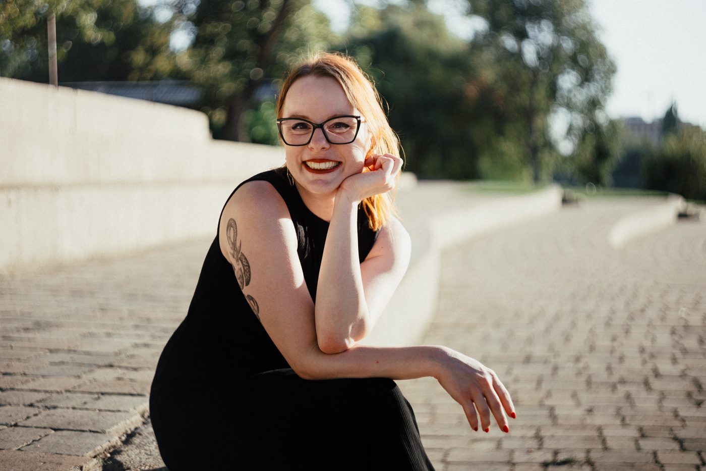 Ágnes Bonácz, AI-DENTITY coach, smiling outdoors in warm light