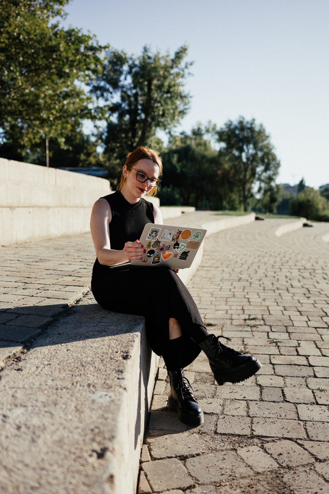 Ágnes working on a laptop outdoors